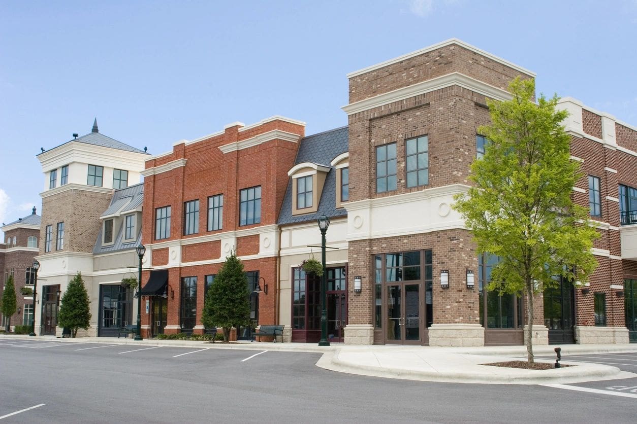 A row of brick buildings on the corner of a street.