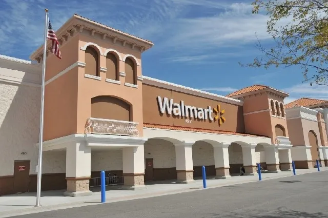 A large walmart store with blue and white poles.